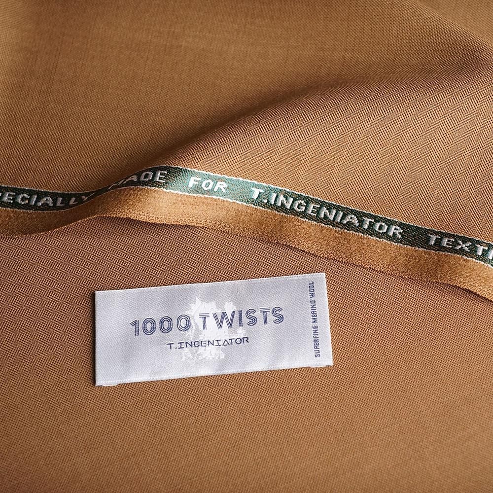 Brown fabric close-up showing its woven edge and label